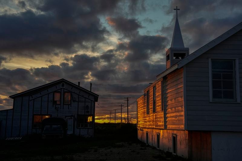 The setting sun illuminates the Anglican Church, Sunday, Aug. 4, 2024, in Churchill, Manitoba. (AP Photo/Joshua A. Bickel)