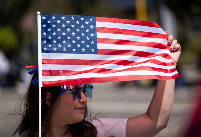 Alejandra Gil holds a flag during the annual Fourth of July Parade in Alameda, Calif. on Thursday, July 4, 2024. (Minh Connors/San Francisco Chronicle via AP)