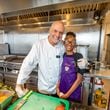 Chef Kameel Srouji and chef Yumara Nash cook salmon and pasta together in the Aviva by Kameel kitchen. Nash, 12, has built a following on social media for her cooking videos.