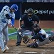 Los Angeles Dodgers' Shohei Ohtani, of Japan, hits a home run scoring Hunter Feduccia during the third inning of a baseball game against the Miami Marlins, Tuesday, Sept. 17, 2024, in Miami. (AP Photo/Wilfredo Lee)