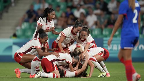Canada's players celebrate after Vanessa Gille scored her side's second goal during the women's Group A soccer match between Canada and France at Geoffroy-Guichard stadium during the 2024 Summer Olympics, Sunday, July 28, 2024, in Saint-Etienne, France. (AP Photo/Silvia Izquierdo)