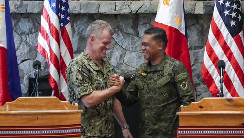 U.S. Indo-Pacific Command Commander Admiral Samuel Paparo, left, and Philippines military chief Gen. Romeo Brawner Jr., shake hands after a press conference on the Mutual Defense Board-Security Engagement Board held at the Philippine Military Academy in Baguio, northern Philippines on Thursday, Aug. 29, 2024. (AP Photo/Aaron Favila)