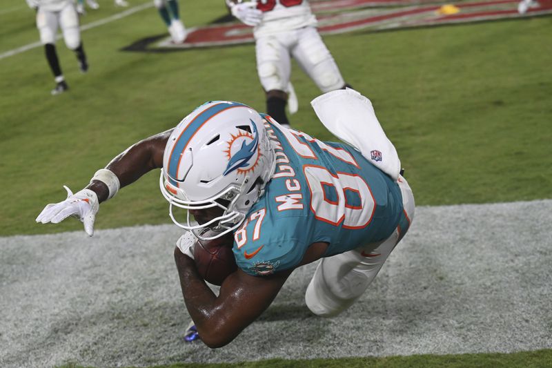 Miami Dolphins wide receiver Kyric McGowan (87) scores a touchdown during the second half of a pre season NFL football game against the Tampa Bay Buccaneers, Friday, Aug. 23, 2024, in Tampa, Fla. (AP Photo/Jason Behnken)