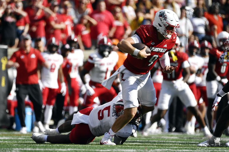 Jacksonville State edge Reginald Hughes (5) attempts to bring down Louisville quarterback Tyler Shough (9) during the second half of an NCAA college football game in Louisville, Ky., Saturday, Sept. 7, 2024. (AP Photo/Timothy D. Easley)