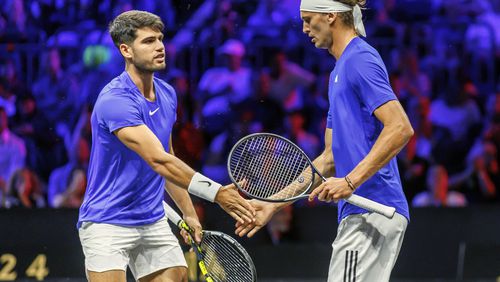 Team Europe's Carlos Alcaraz, left, and Alexander Zverev slap hands during a doubles match against Team World's Ben Shelton and Taylor Fritz on the first day of the Laver Cup tennis tournament at the Uber arena in Berlin, Germany, Friday, Sept. 20, 2024. (Andreas Gora/dpa via AP)