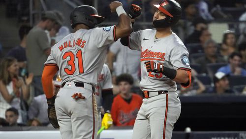 Baltimore Orioles' Cedric Mullins, left, and Ramón Urías celebrate a home run hit by Urías during the fifth inning of a baseball game against the New York Yankees, Wednesday, June 19, 2024, in New York. (AP Photo/Pamela Smith)