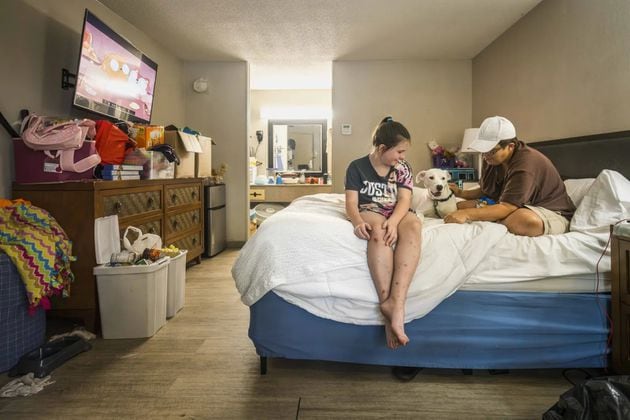 Melissa Bullard (right) with her daughter Heaven and their dog in the bed at the Days Inn in Brunswick, Georgia, Friday, Sept. 6, 2024. (Photo Courtesy of Justin Taylor/The Current GA)