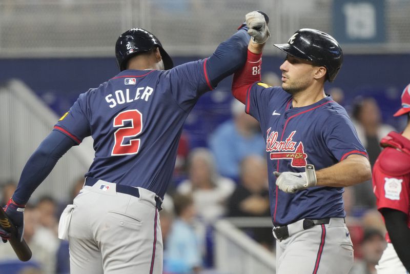 Atlanta Braves' Matt Olson celebrates a two-run home run with Jorge Soler (2) during the seventh inning of a baseball game against the Miami Marlins, Saturday, Sept. 21, 2024, in Miami. (AP Photo/Marta Lavandier)