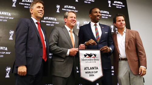061622 Atlanta: Dietmar Exler, Chief Operating Officer Mercedes-Benz Stadium (from left), Governor Brian Kemp, Mayor Andre Dickens, and Dan Corso, Atlanta Sports Council, take the stage during the Host City announcement press conference for the 2026 World Cup at Mercedes-Benz Stadium on Thursday, June 16, 2022, in Atlanta.     “Curtis Compton / Curtis.Compton@ajc.com”