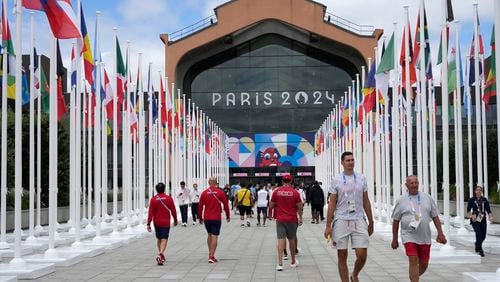 FILE - People walk in front of the canteen in the Olympic Village, at the 2024 Summer Olympics, Monday, July 22, 2024, in Paris, France. (AP Photo/Michel Euler, Pool, File)