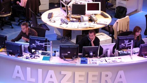 Al Jazeera English channel staff prepare for the first broadcast in Doha news room in Qatar on Tuesday, Nov. 14, 2006. AP Photo/ Hamid Jalaudin