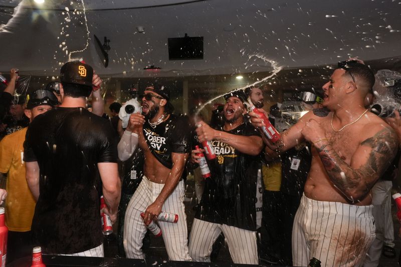 San Diego Padres players celebrate in the dugout after defeating the Atlanta Braves in Game 2 of an NL Wild Card Series baseball game Wednesday, Oct. 2, 2024, in San Diego. (AP Photo/Gregory Bull)