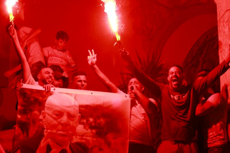 Supporters of Tunisian president and candidate for re-election Kais Saied celebrate after the announcement of the provisional results for the presidential elections, in the capital Tunis, Tunisia, Sunday, Oct. 6, 2024. (AP Photo/Anis Mili)