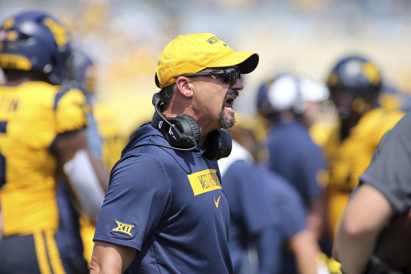 West Virginia coach Neal Brown reacts during the first half of an NCAA college football game against Penn State in Morgantown, W.Va., Saturday, Aug. 31, 2024. (AP Photo/Kathleen Batten)