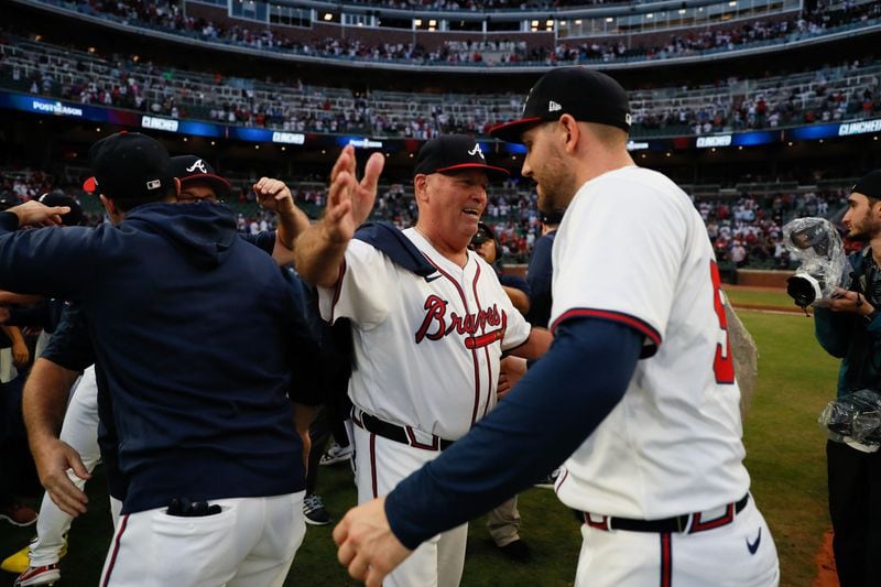 Atlanta Braves manager Brian Snitker (43) celebrates with Atlanta Braves pitcher Dylan Lee (52) after their 3-0 win over the Mets in the second game of Monday’s doubleheader at Truist Park to clinch the 2024 MLB playoffs on Monday, Sept. 30, 2024, in Atlanta. 
(Miguel Martinez/ AJC)