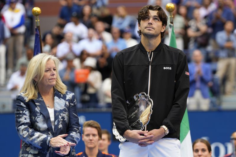 Taylor Fritz, of the United States, holds the finalist trophy after losing to Jannik Sinner, of Italy, in the men's singles final of the U.S. Open tennis championships, Sunday, Sept. 8, 2024, in New York. (AP Photo/Kirsty Wigglesworth)