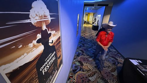 Downwinder Paul Pino heads through the SALA Event Center toward the screening of "First We Bombed New Mexico" during the Oppenheimer Film Festival in Los Alamos, New Mexico on Saturday, Aug. 17, 2024. The documentary tells the stories of those who lived near the Trinity Test Site when the U.S. government detonated the first atomic bomb and the Native Americans who worked in the uranium industry. (AP Photo/Susan Montoya Bryan)