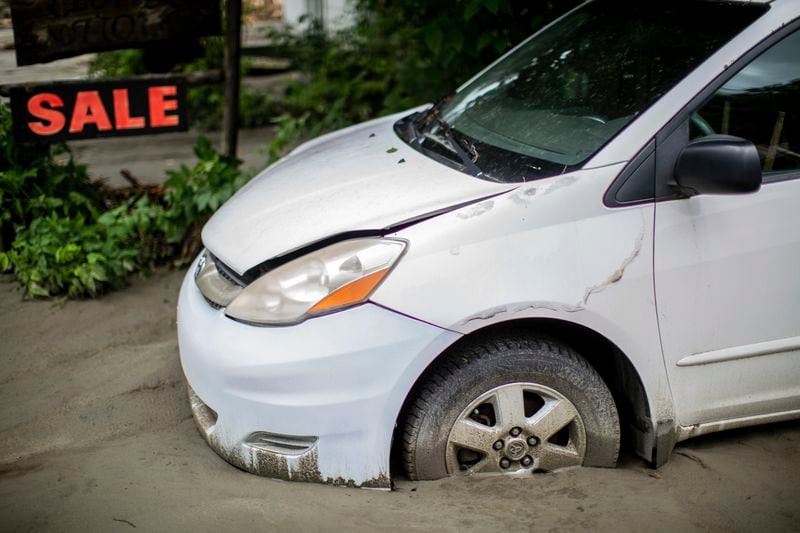 A vehicle is buried in silt following flooding caused by the remnants of Hurricane Beryl, Thursday, July 11, 2024, in Plainfield, Vt. (AP Photo/Dmitry Belyakov)