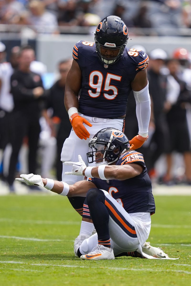 Chicago Bears cornerback Kyler Gordon (6) reacting after sacking Cincinnati Bengals quarterback Logan Woodside (11) during the first half of an NFL preseason football game, Saturday, Aug. 17, 2024, at Soldier Field in Chicago. Also on the field is Chicago Bears defensive end DeMarcus Walker (95). (AP Photo/Charles Rex Arbogast)