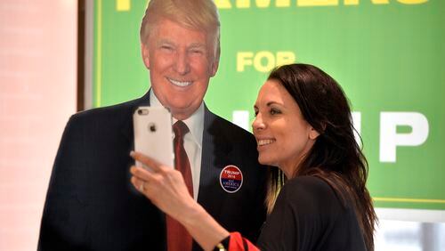 Ginny Ehrhart poses for a selfie with a life-size, cardboard cutout of Trump during the Georgia Republican Party State Convention in Augusta, June 3. (Michael Holahan / The Augusta Chronicle)
