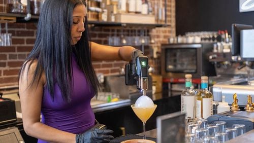 Aja Wolfe, the owner of Sober Social in Castleberry Hill, mixes a nonalcoholic drink behind the bar. / Courtesy of Aja Wolfe