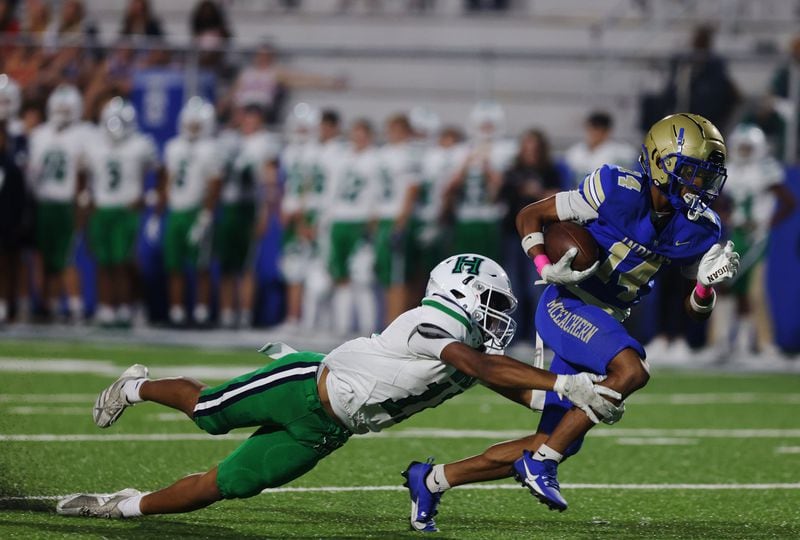 McEachern's Zavion Harris runs from a defender during a Friday night loss to Harrison High School.