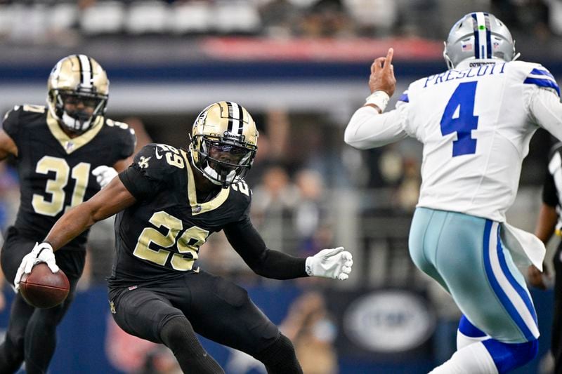 New Orleans Saints cornerback Paulson Adebo (29) runs with the ball after intercepting a pass by Dallas Cowboys quarterback Dak Prescott (4) during the first half of an NFL football game, Sunday, Sept. 15, 2024, in Arlington, Texas. (AP Photo/Jerome Miron)