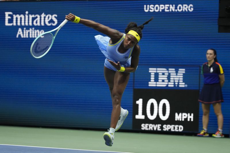 Coco Gauff, of the United States, serves to Emma Navarro, of the United States, during the fourth round of the U.S. Open tennis championships, Sunday, Sept. 1, in New York. 2024. (AP Photo/Pamela Smith)