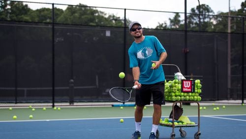 Raian Luchici, 35, Director of Tennis at Bitsy Grant Tennis Center, gives lessons to a young tennis player at the center in Atlanta, Ga., on Friday, June 28, 2019. (Casey Sykes for The Atlanta Journal-Constitution)