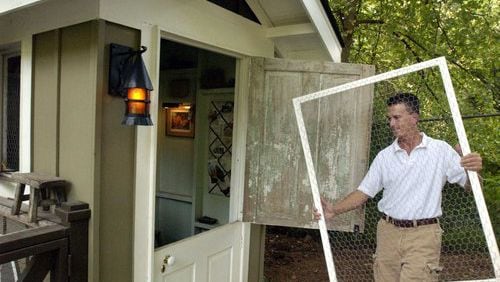 Scott Pluckhahn prepares his chickens for sleep in their cozy chicken coop that's in the yard of his Decatur home.