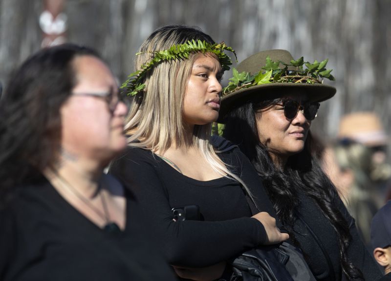 Mourners gather outside Turangawaewae Marae for the funeral of New Zealand's Māori King, Kiingi Tuheitia Pootatau Te Wherowhero VII, in Ngaruawahia, New Zealand, Thursday, Sept 5, 2024. (AP Photo/Alan Gibson)