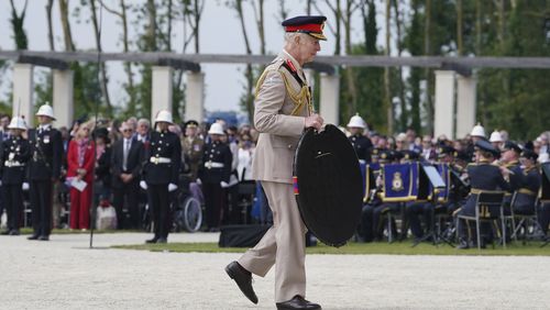 King Charles III lays a wreath during the UK national commemorative event for the 80th anniversary of D-Day, held at the British Normandy Memorial in Ver-sur-Mer, Normandy, France, Thursday June 6, 2024. (Gareth Fuller, Pool Photo via AP)