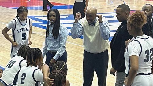Lovejoy coach Cedric King talks to his team during a timeout in the fourth quarter of the Wildcats' 71-56 victory over Rockdale County in the Class 6A girls basketball semifinals on Saturday, March 5, 2022, at the University of West Georgia.