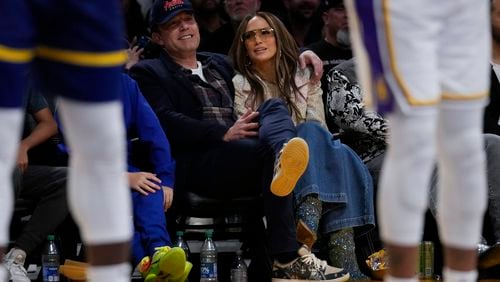 FILE - Ben Affleck and Jennifer Lopez watch an NBA basketball game between the Golden State Warriors and the Los Angeles Lakers in Los Angeles, March 16, 2024. (AP Photo/Ashley Landis, File)