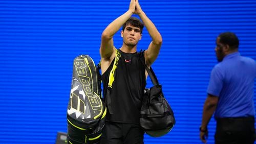 Carlos Alcaraz, of Spain, gestures to fans after losing to Botic van De Zandschulp, of the Netherlands, in a second round match of the U.S. Open tennis championships, Thursday, Aug. 29, 2024, in New York. (AP Photo/Frank Franklin II)