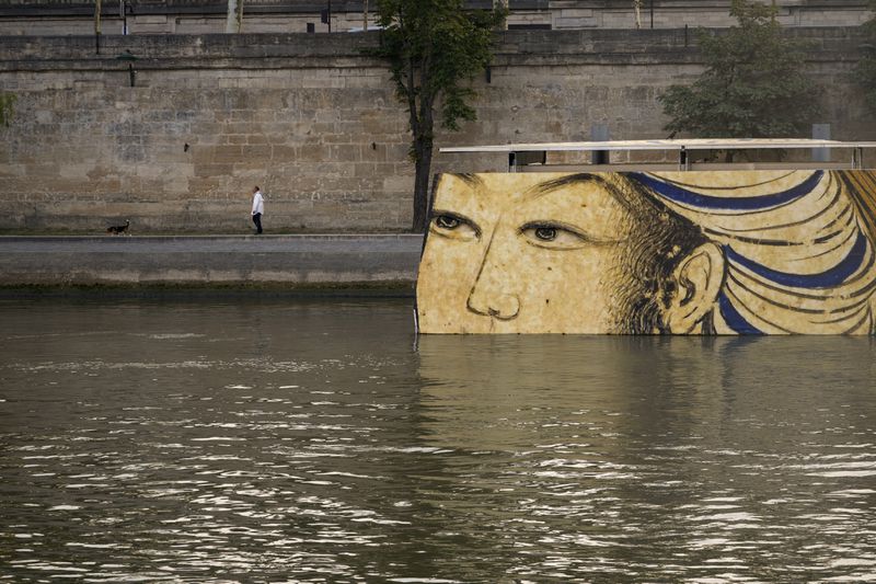 FILE - Reproductions of artworks decorate the banks of the River Seine at the 2024 Summer Olympics, Tuesday, July 30, 2024, in Paris, France. Concerns over water quality in the Seine River resurfaced at the Paralympic Games on Thursday when organizers changed the schedule for para triathlon races. (AP Photo/ Dar Yasin, File)