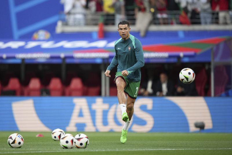 Portugal's Cristiano Ronaldo kicks the ball as he warms up for the Group F match between Portugal and Czech Republic at the Euro 2024 soccer tournament in Leipzig, Germany, Tuesday, June 18, 2024. (AP Photo/Ebrahim Noroozi)