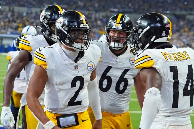 Pittsburgh Steelers quarterback Justin Fields (2) celebrates after rushing for a touchdown, his second of the game, during the second half of an NFL football game against the Indianapolis Colts, Sunday, Sept. 29, 2024, in Indianapolis. (AP Photo/Darron Cummings)