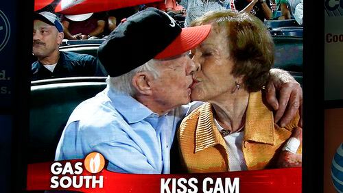 Former President Jimmy Carter kisses his wife, Rosalynn, on the "Kiss Cam" during a baseball game between the Braves and the Toronto Blue Jays on Thursday at Turner Field in Atlanta. Carter recently announced he has cancer. (AP Photo/John Bazemore)