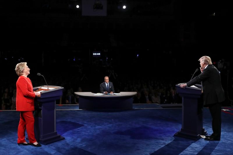 FILE - Democratic presidential nominee Hillary Clinton listens as Republican presidential nominee Donald Trump answers a question during the presidential debate in Hempstead, N.Y., Sept. 26, 2016. (Joe Raedle/Pool via AP, File)