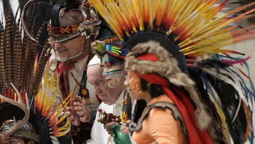 FILE - Pope Francis poses for a family picture with a group of Mexican pilgrims wearing traditional clothes during the weekly general audience at the Vatican, Aug. 10, 2022. (AP Photo/Andrew Medichini, File)