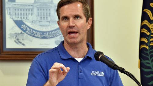Kentucky Gov. Andy Beshear addresses a crowd gathered at the Breathitt Co. Courthouse to discuss progress in flood recovery efforts in Jackson, Ky., Friday, July 26, 2024. (AP Photo/Timothy D. Easley)