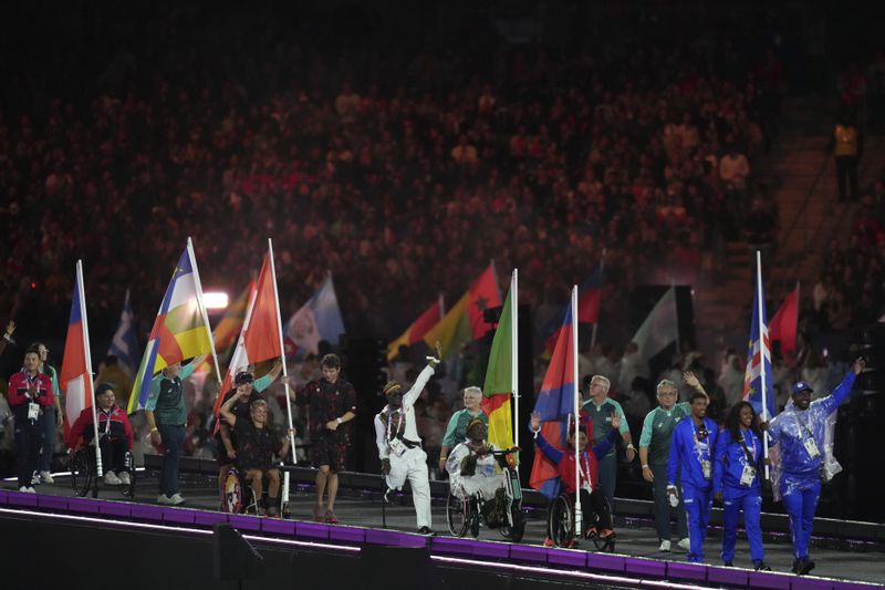 Athletes from different delegations parade during the closing ceremony of the 2024 Paralympics, Sunday, Sept. 8, 2024, in Paris, France. (AP Photo/Thibault Camus)