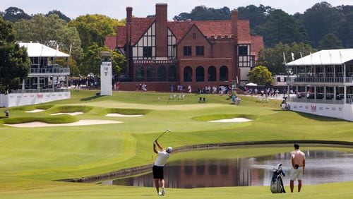 Scottie Scheffler hits his fairway shot on the 18th hole with the clubhouse in the background during a practice round for the Tour Championship at East Lake Golf Club, on Wednesday, Aug. 28, 2024, in Atlanta. (Jason Getz / AJC)
