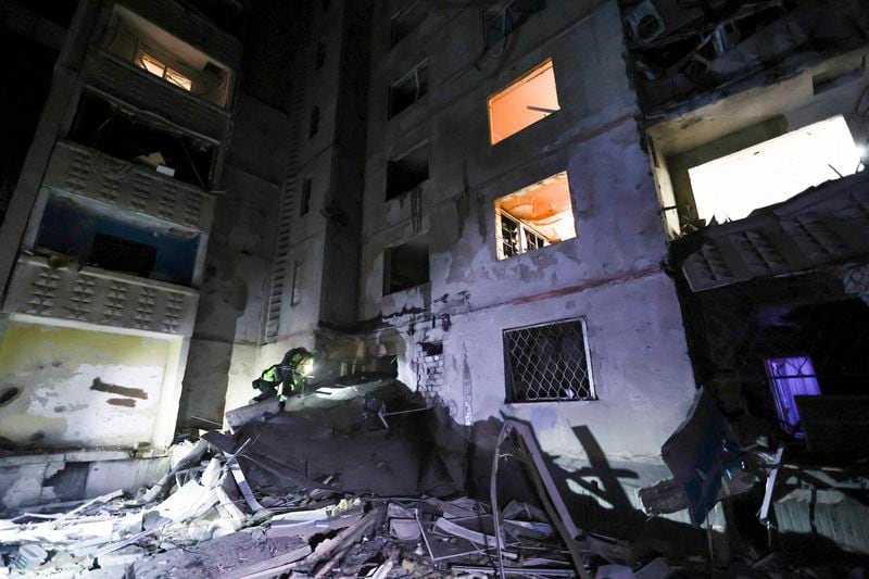 Emergency services workers look to move rubble and find injured after a Russian strike on a residential building in Kharkiv, Ukraine early Sunday Sept. 22, 2024. (Kharkiv Regional Military Administration via AP)