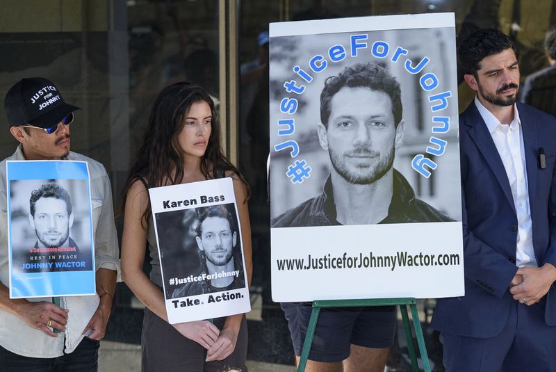 Gina Eva, second from left, and Micah Parker, "Vampire Diaries," actor, producer, and organizer of Justice for Johnny Wactor, right, attend a news conference outside the Clara Shortridge Foltz Criminal Justice Center in Los Angeles, Monday, Aug. 19, 2024. Los Angeles County District Attorney George Gascon plans to announces charges Monday in the killing of former “General Hospital” actor Wactor. (AP Photo/Damian Dovarganes)