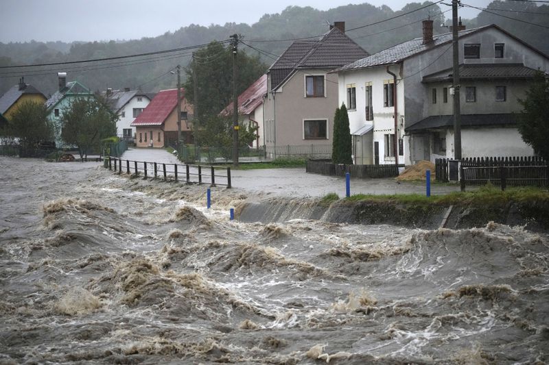 The Bela River flows past homes during floods in Mikulovice, Czech Republic, Saturday, Sept. 14, 2024. (AP Photo/Petr David Josek)