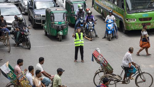 A student directs traffic in Dhaka, Bangladesh, on Aug. 8, 2024. (AP Photo/Rajib Dhar)