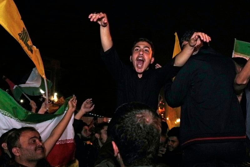 Demonstrators celebrate Iran's missile strike against Israel during a gathering in front of the British Embassy in Tehran, Iran, Tuesday, Oct. 1, 2024. (AP Photo/Vahid Salemi)