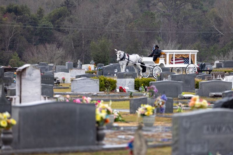 A horse and carriage carry the casket of Army Reservist Sgt. Kennedy L. Sanders through Oakland Cemetery in Waycross on Saturday, Feb. 17, 2024. Sanders was killed in a drone attack in January in Jordan. (Arvin Temkar/arvin.temkar@ajc.com)